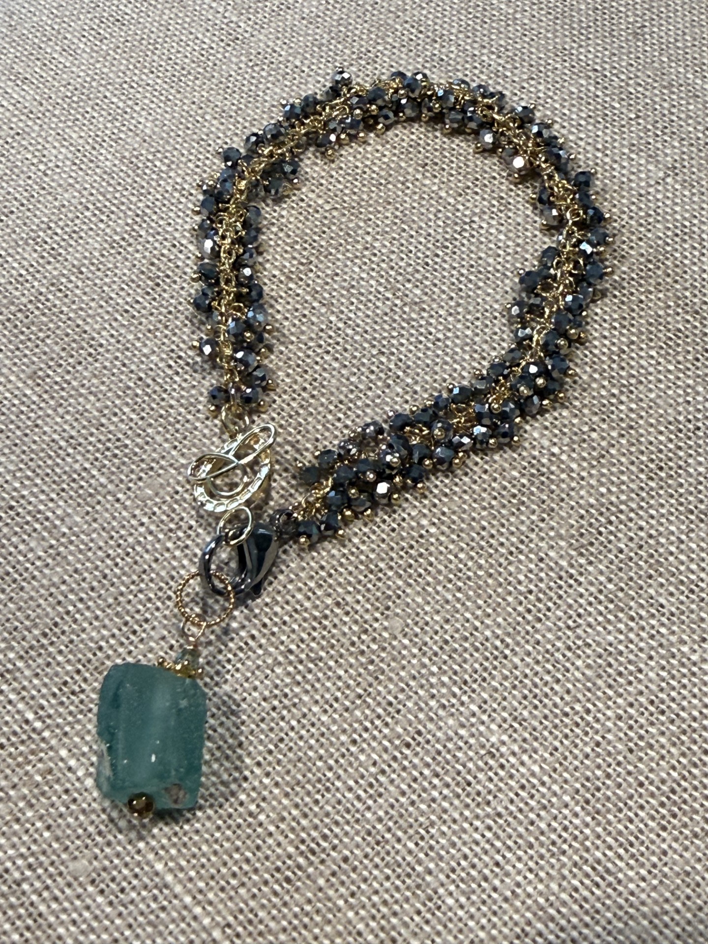 Hand-tied, faceted pyrite balls on gold wire bracelet