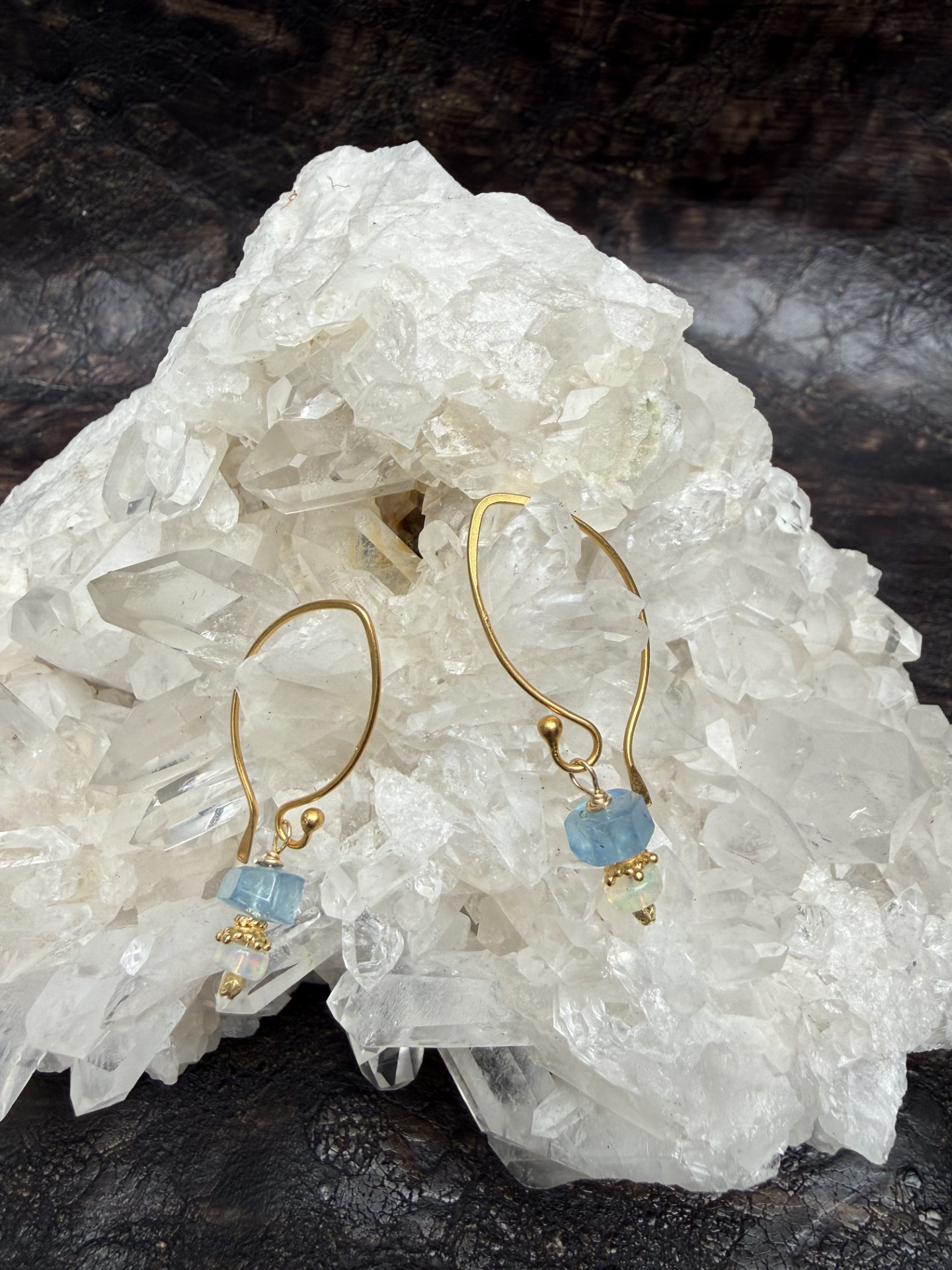 Aquamarine and opal earrings with gold details on long thin gold tops