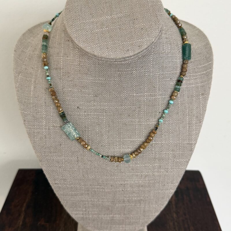 Roman glass, turquoise, cactus sapphires, chalcedony, and gold and silver details