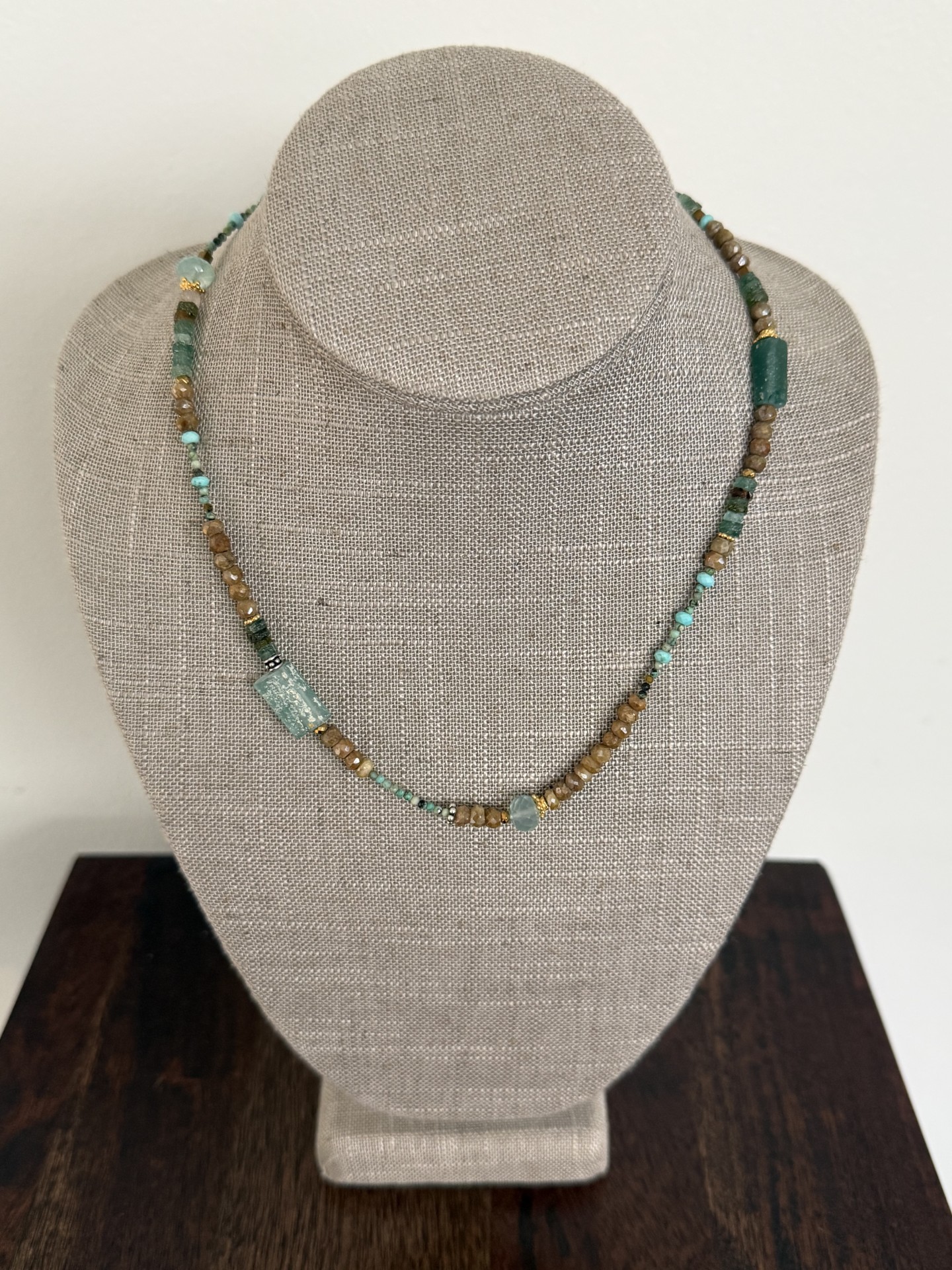 Roman glass, turquoise, cactus sapphires, chalcedony, and gold and silver details