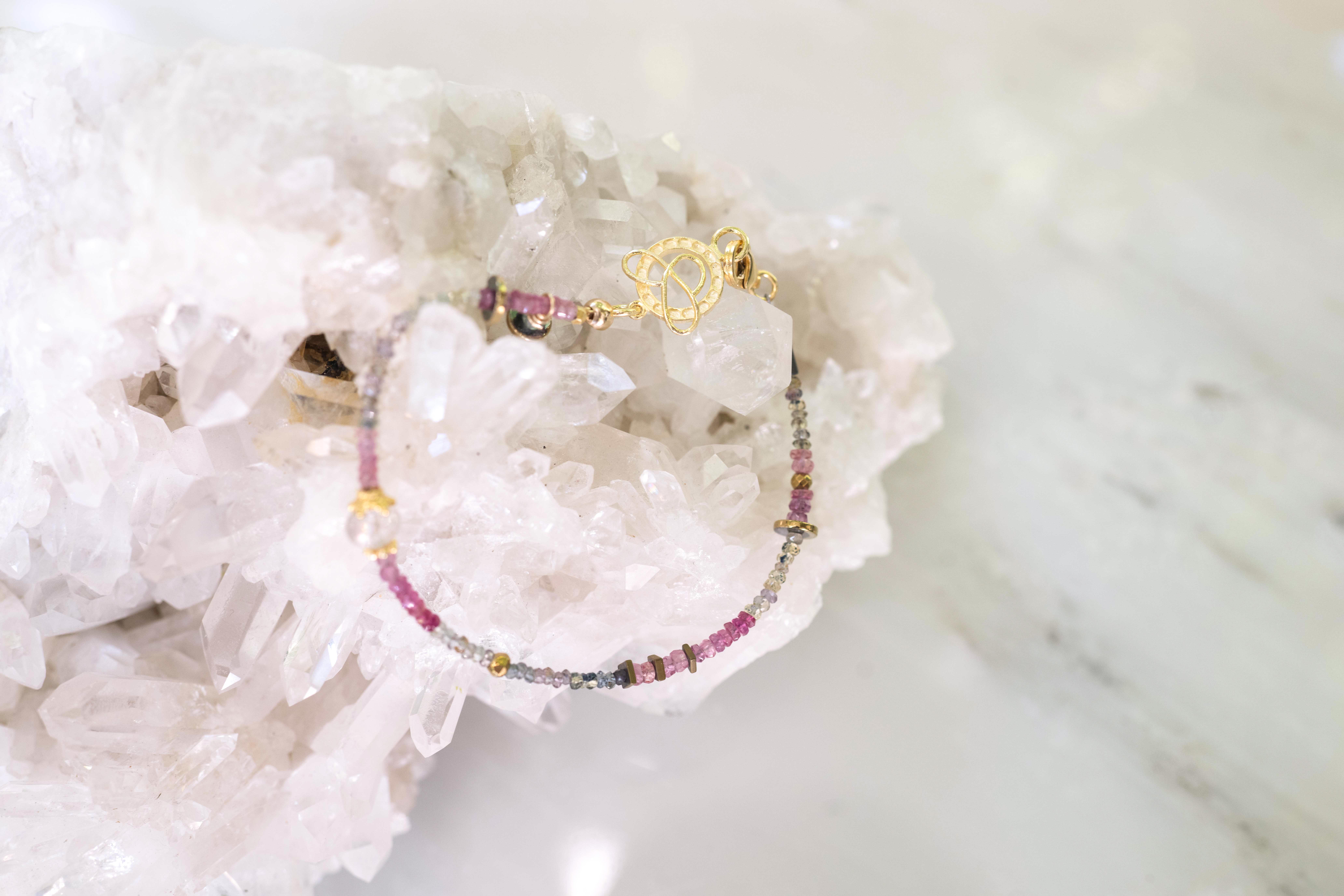 Pink sapphires with green and multicolored sapphires, gold, and hematite details, 7.5"