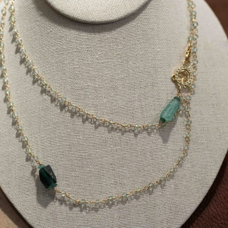 Hand-tied aqua marine with gold wire and roman glass details, 36"