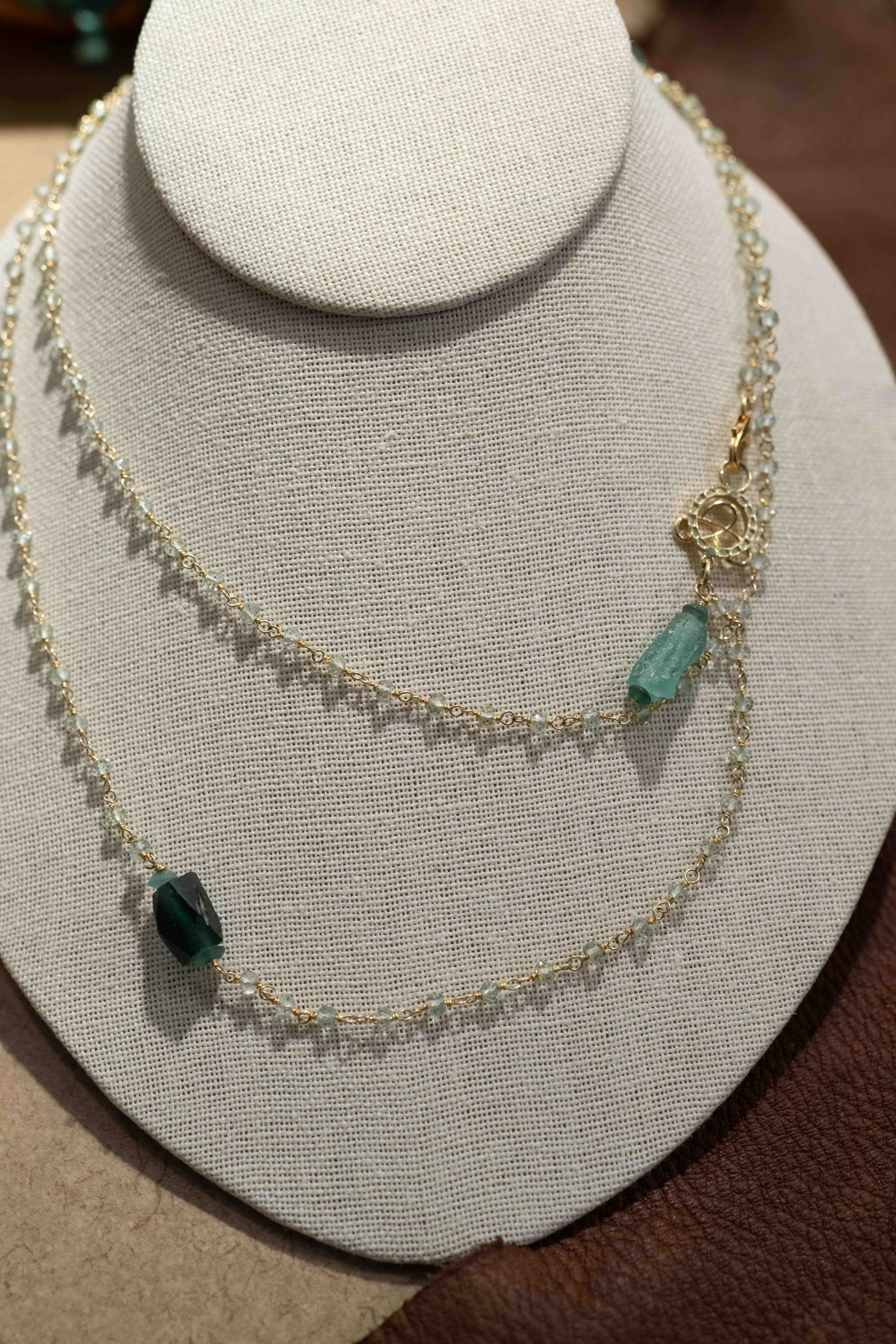 Hand-tied aqua marine with gold wire and roman glass details, 36"